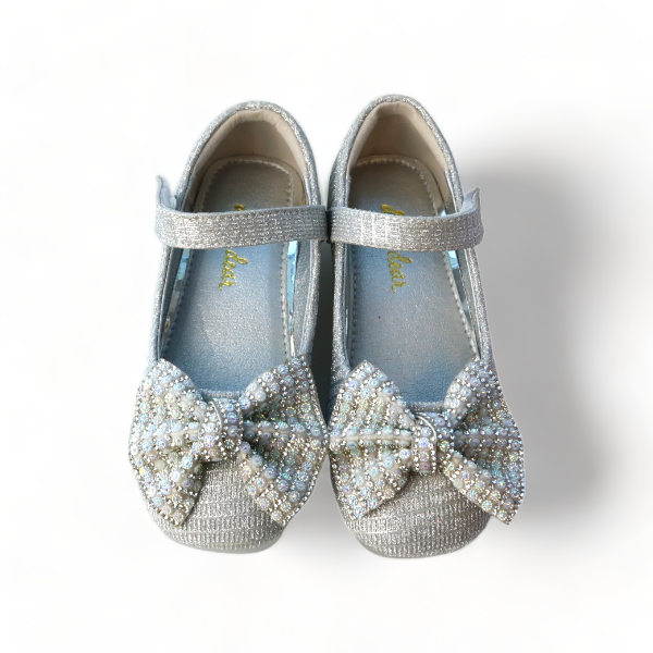 Top view of girls silver sparkle Mary Jane shoes showing rhinestone bow and adjustable strap closure