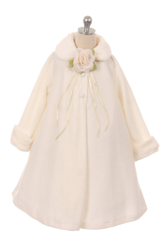 Girls' ivory fleece cape coat with faux fur collar and corsage accent on mannequin, elegant winter formal outerwear for special occasions