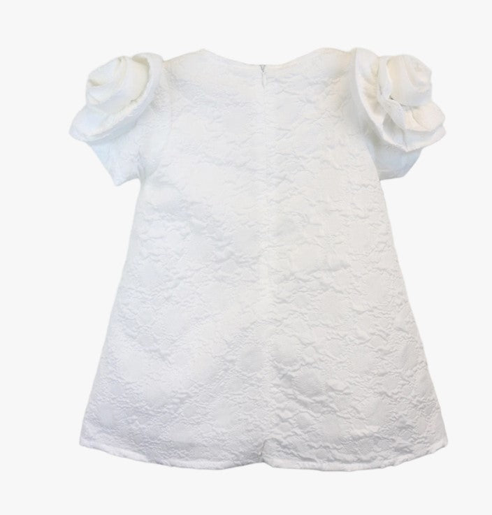 Back view of white textured brocade A-line dress with rosette shoulder detail for girls