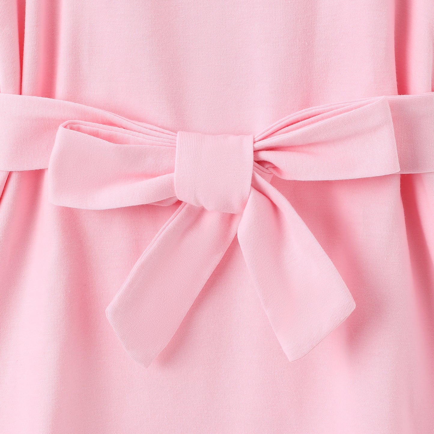 Close up view of light pink toddler belted dress showing belt