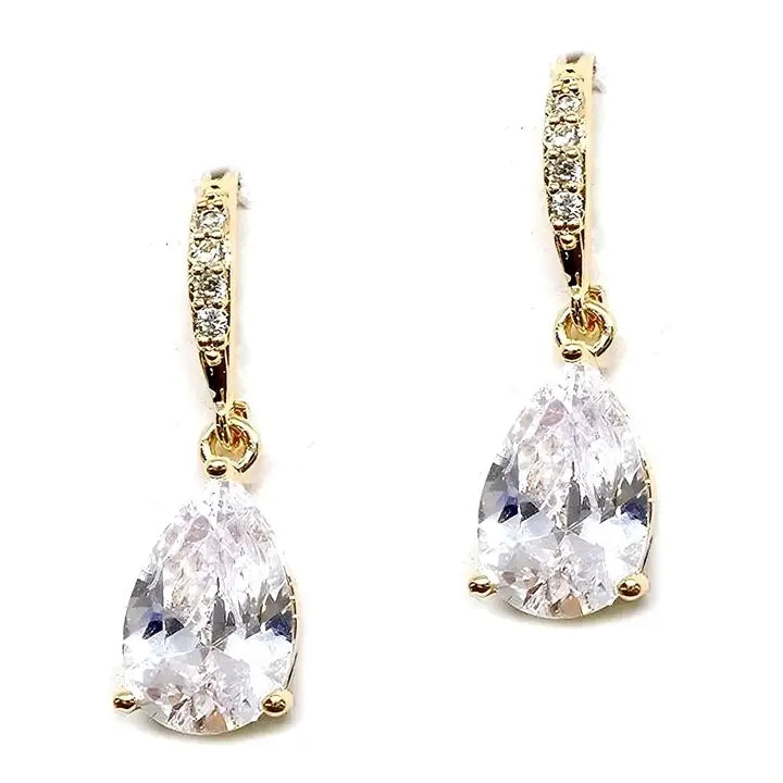 Gold earrings with teardrop-shaped clear gemstones on a white background