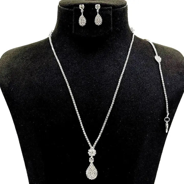 Cubic zirconia pear pendant necklace bracelet and earring set with rhinestone chain displayed on black velvet jewelry bust