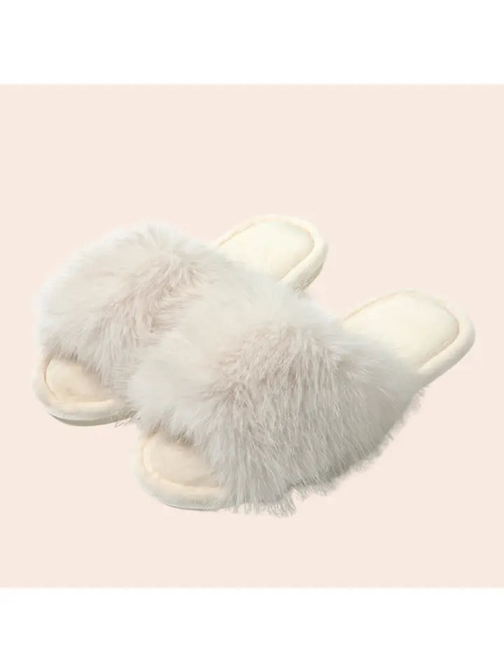 White plush faux fur slide slippers with fluffy strap and open toe design on cream background
