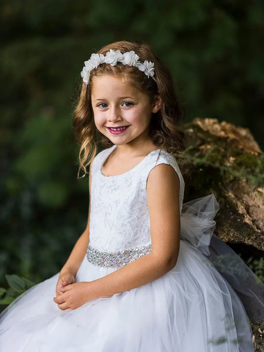 Side view of white flower girl dress with lace bodice and voluminous tea-length tulle skirt