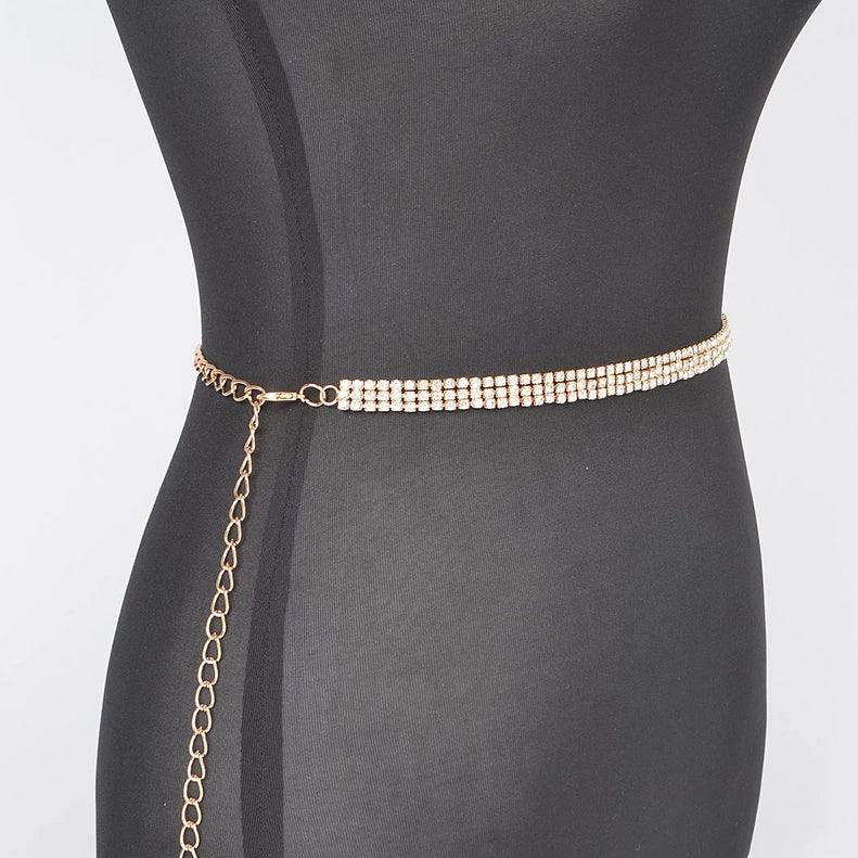 Gold chain belt on a mannequin with a plain background