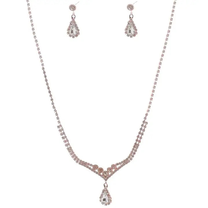 Rose Gold Crystal teardrop necklace and earring set with rhinestone V-shaped chain and matching drop earrings on white background