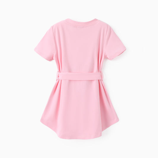 Back view of light pink toddler belted dress showing curved hem