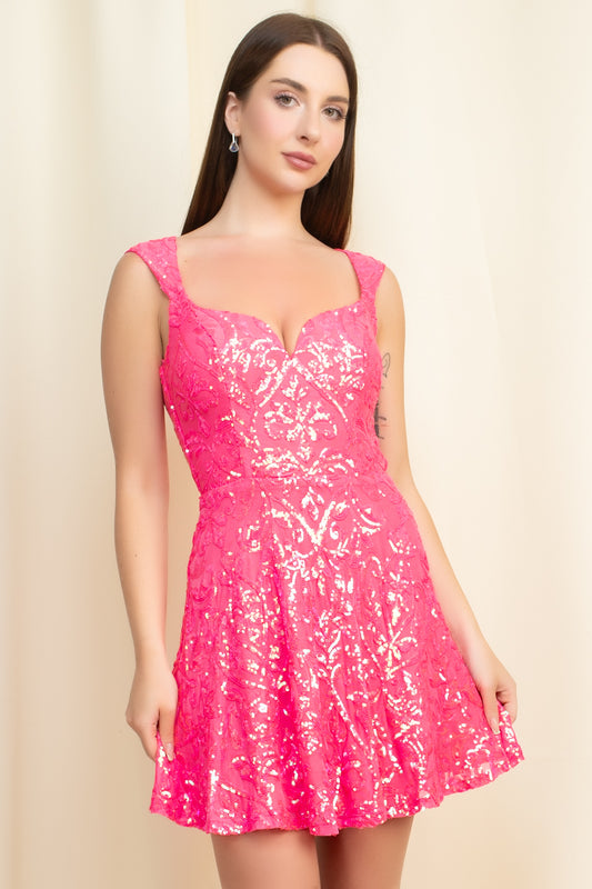 Woman wearing a pink sequin dress against a beige background