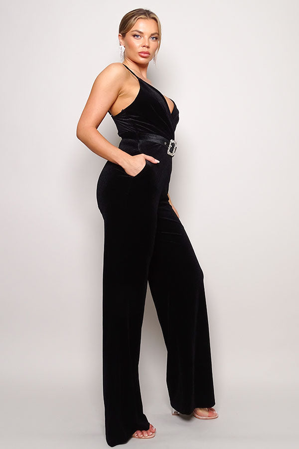 Woman wearing a black jumpsuit on a white background