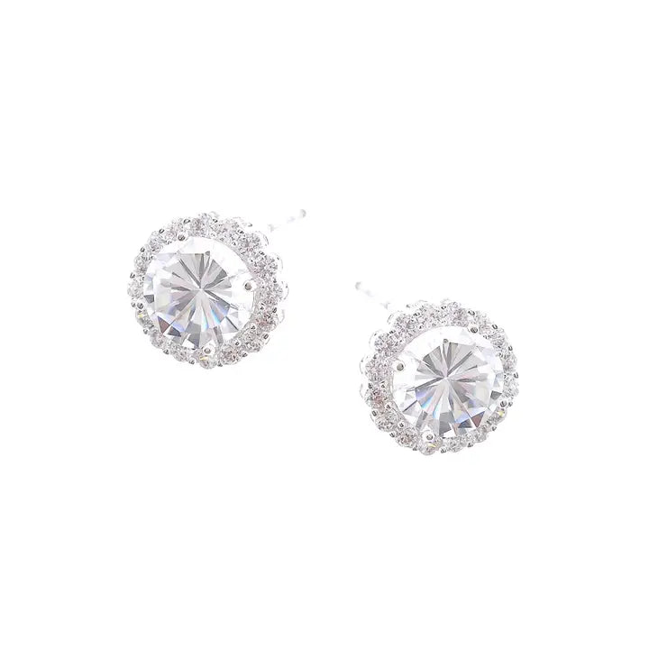 Pair of silver earrings with clear gemstones on a white background
