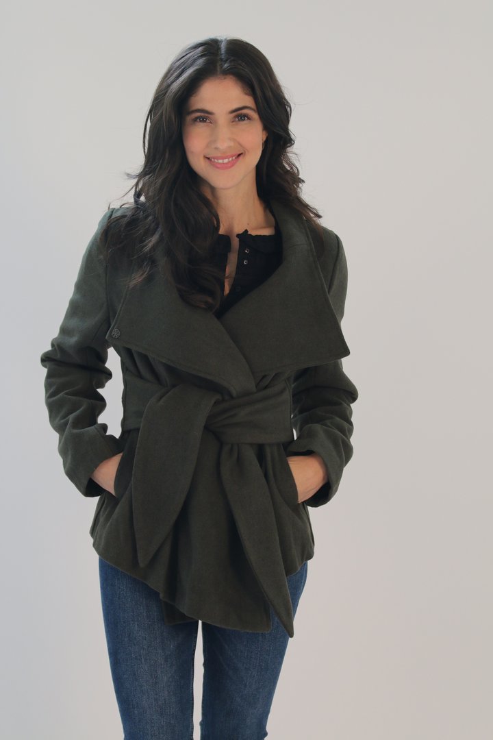 Woman wearing olive green Ciao Milano Dramatic tie-waist jacket with belted waist and convertible collar