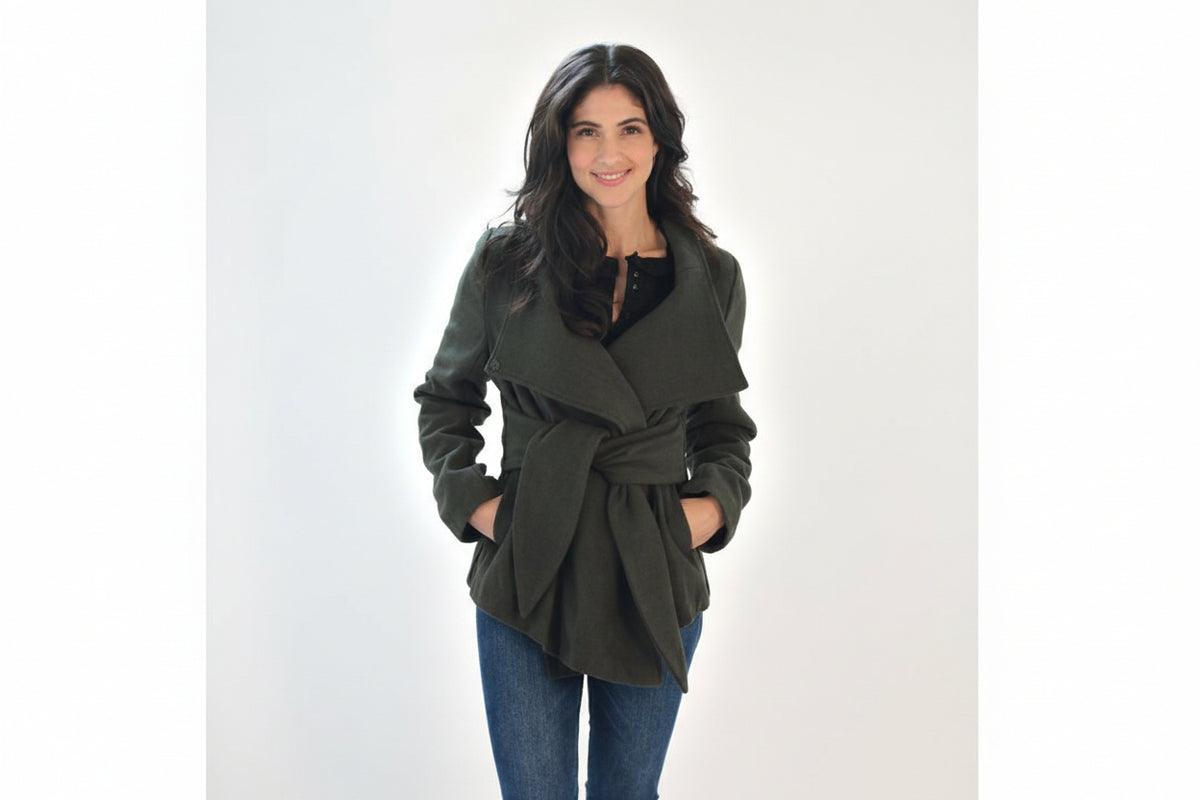 Woman wearing olive green belted wrap coat with high collar