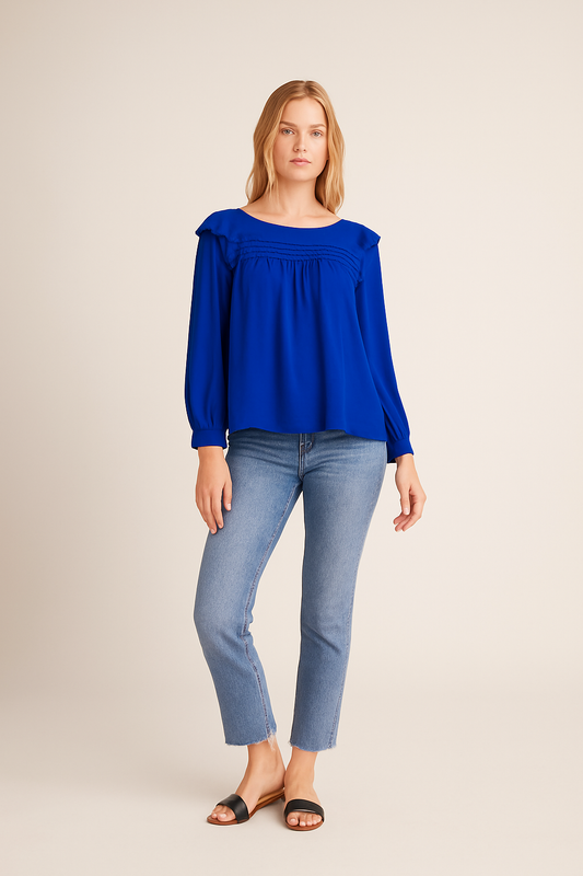 Woman wearing a blue top and light blue jeans on a beige background