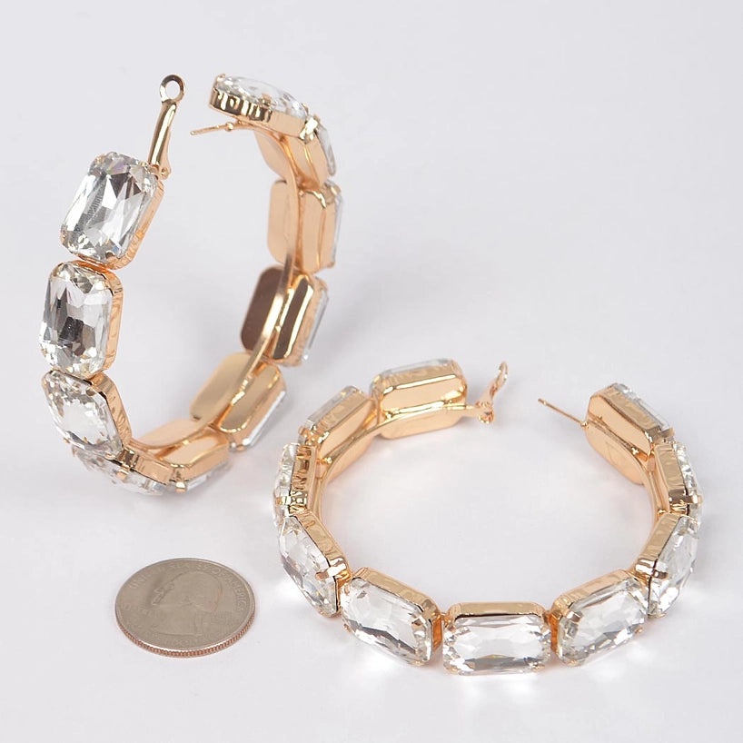 Pair of emerald-cut cubic zirconia XL hoop earrings in gold with quarter coin for size reference, showing 2.75 inch diameter