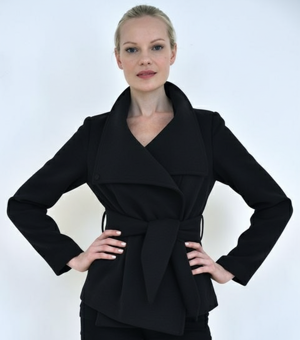 Close-up detail of black Ciao Milano Helena wrap coat showing tie-waist belt and elegant drape