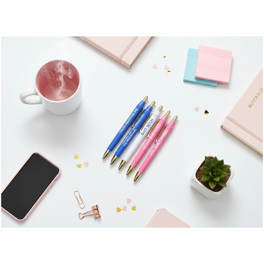 Busy Bitch pen set styled on desk with coffee mug, planner, and office accessories in feminine workspace flat lay