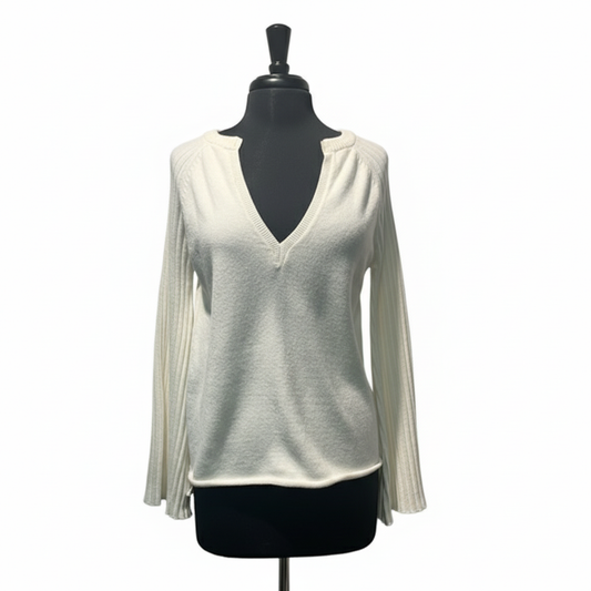 Front view of cream ribbed knit sweater with deep V-neckline and bell sleeves