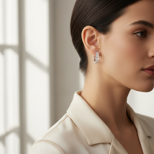 Woman wearing delicate cubic zirconia square cut hoop earrings with metal star accents, close-up profile view showing rhodium-plated hoops