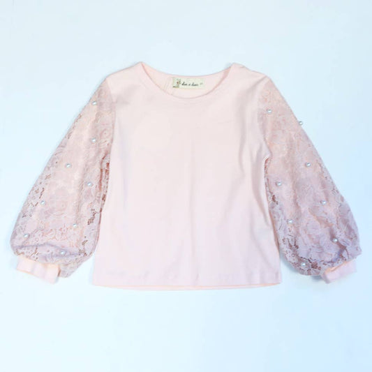 Girls' blush pink top with pearl-embellished lace lantern sleeves on light blue background
