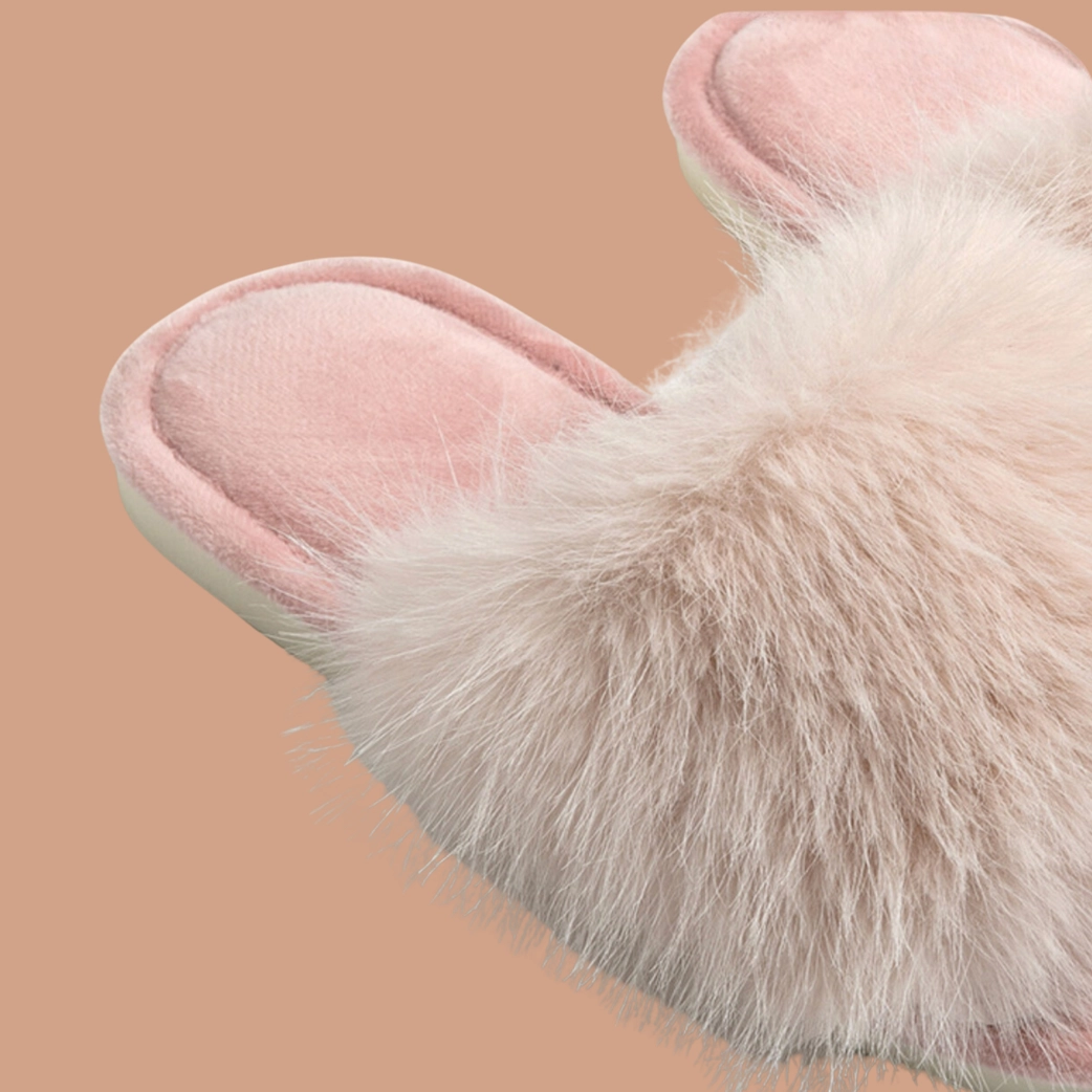Close-up detail of blush pink faux fur slipper showing plush texture and cushioned insole