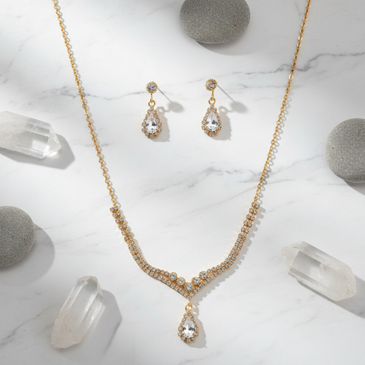 Gold crystal jewelry set flat lay with abstract stone