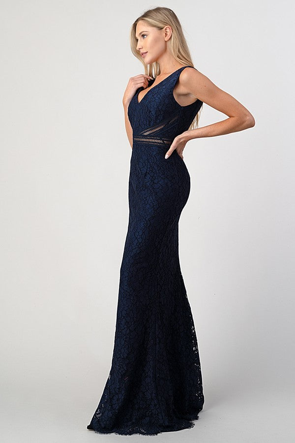 Woman wearing navy lace gown with mesh waist detail, side angle showing fitted bodice and mermaid skirt silhouette