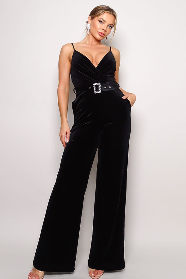 Woman wearing a velvet jumpsuit with rhinestone belt - black wide leg