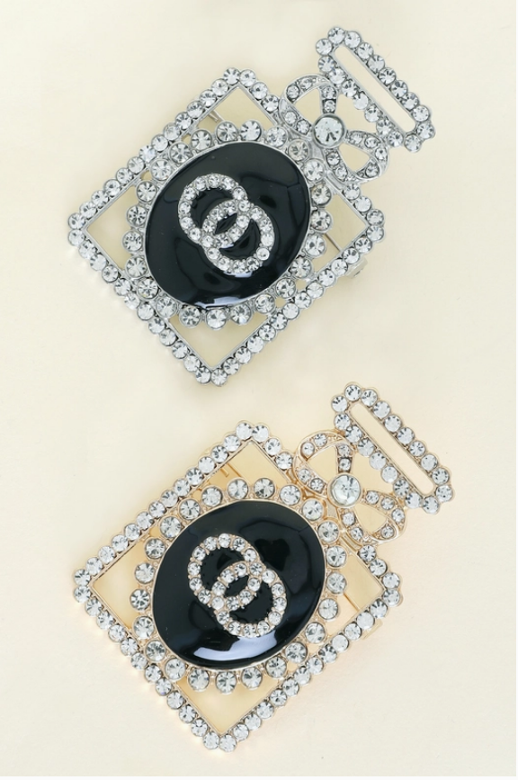 Pair of crystal pavé perfume bottle brooches in gold and silver with black enamel centers