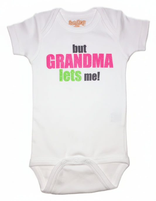 Baby white onesie with text 'but GRANDMA lets me!' in pink and green print.