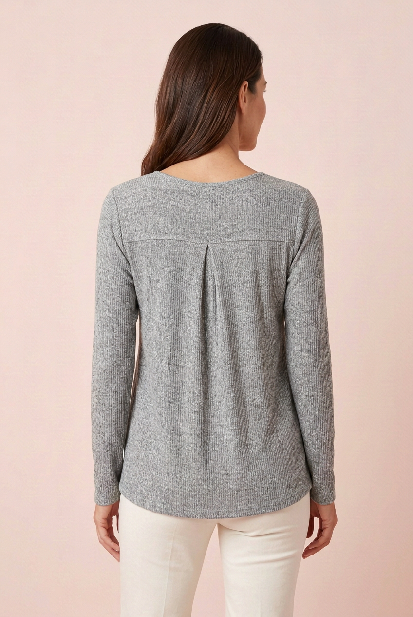 Heather gray ribbed long sleeve top showing horizontal back seam and center pleat, styled with ivory trousers, back view