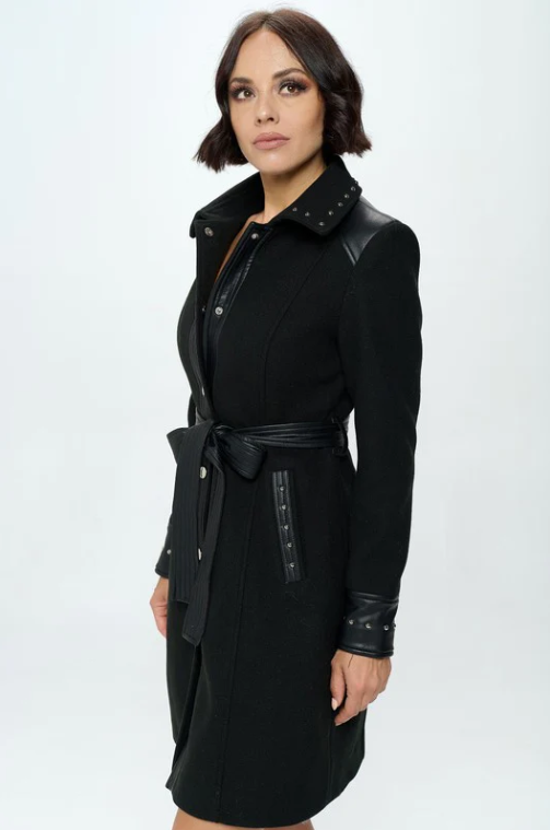 Close-up detail of black faux wool coat showing stud embellishments on belt and button-front closure