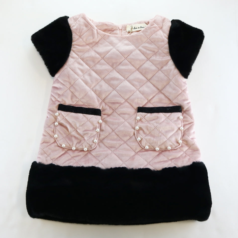 A girls' faux suede quilted fur trim dress in pink with black accents and pockets on the front.