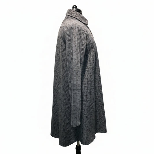 Grey plaid coat side view showing hi-low hemline, relaxed silhouette, and intricate check pattern texture