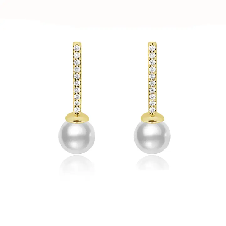 Pearl drop earrings with cubic zirconia pavé bar in gold finish against white background