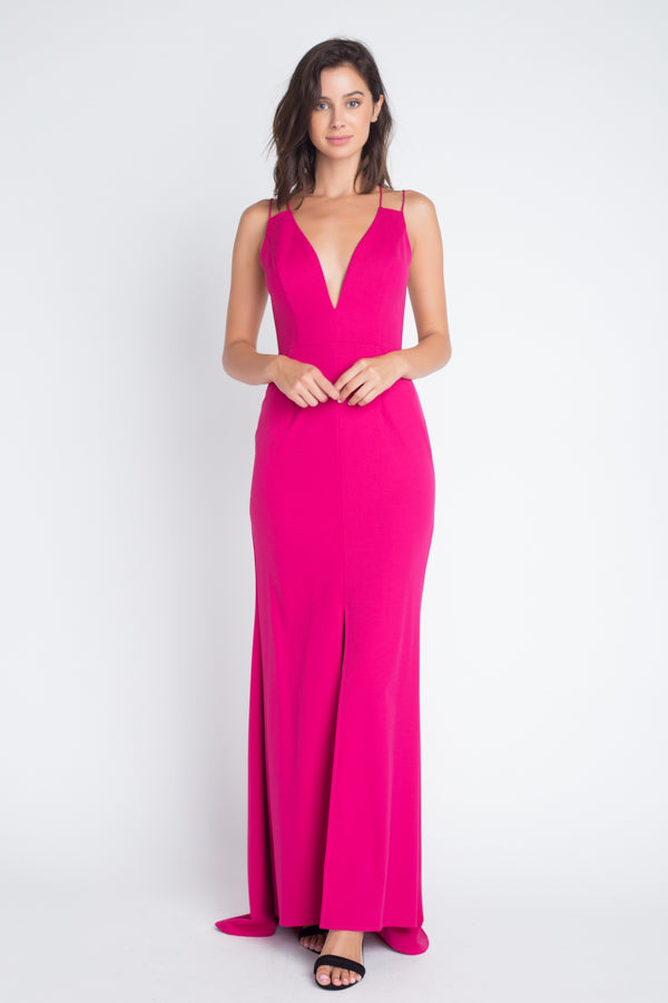 Woman wearing hot pink gown with deep V-neckline and spaghetti straps, full-length front view showing floor-length silhouette