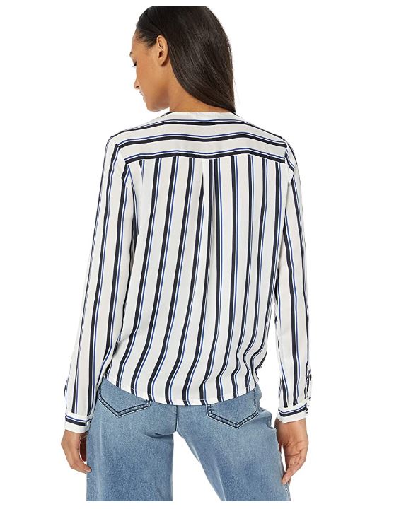 Back view of woman wearing white and navy striped long sleeve blouse with light blue jeans