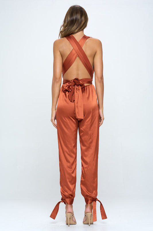 Rust satin plunge halter wrap jumpsuit back view – X-cross open back with self-tie bow waist and tapered ankle tie pants