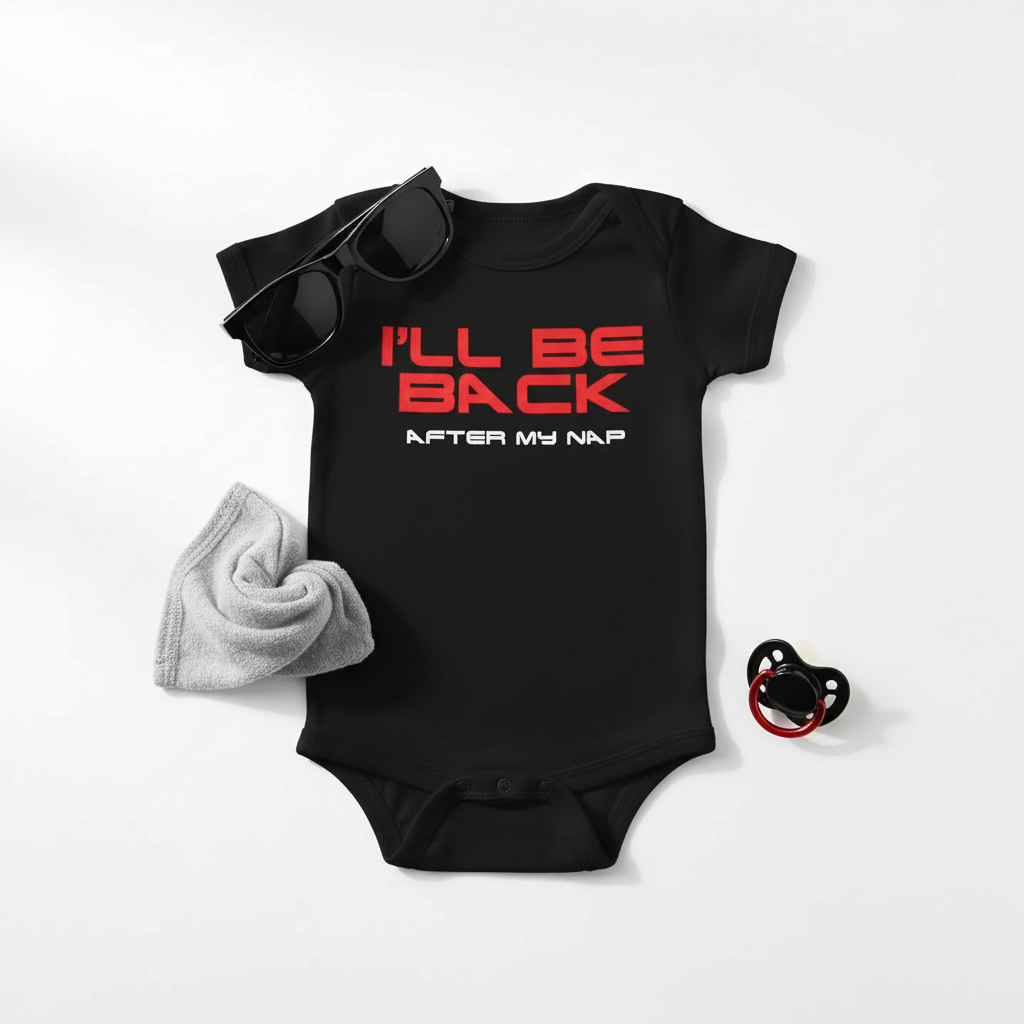 Minimalist flat lay of black Terminator baby onesie with baby sunglasses and simple props on white background