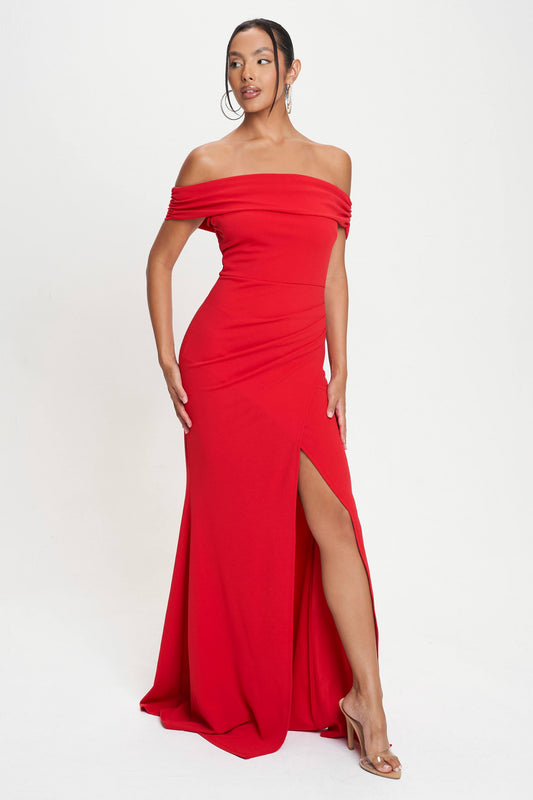 This image displays an elegant off-shoulder foldover maxi dress in a vibrant red color. The dress features a striking design with a foldover neckline that elegantly frames the shoulders, enhancing its graceful appeal.