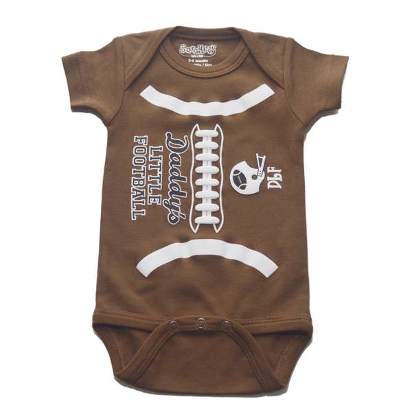 A brown onesie with white graphic print of a football and the text 'Daft Luke's Football'. It also features a white bow tie design on the front.