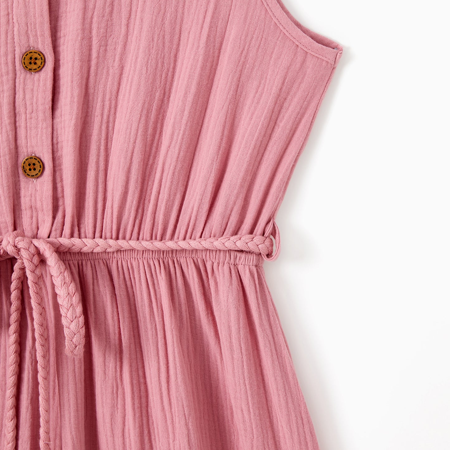 Pink dress with button details on a white background