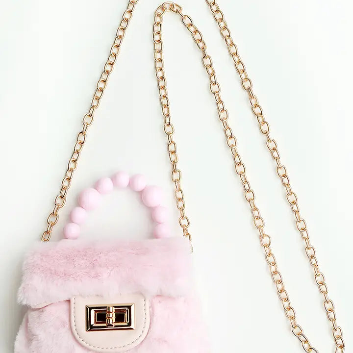 Close up of Girls' Pink Faux Fur Purse with Pearl Handle & Gold Chain