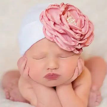 Infant baby girl in pink hospital beanie with large silk rose flower and pearl center