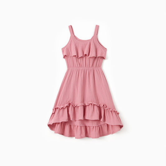Pink dress with ruffled layers on a white background