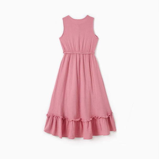 Pink dress with ruffled hem on a white background