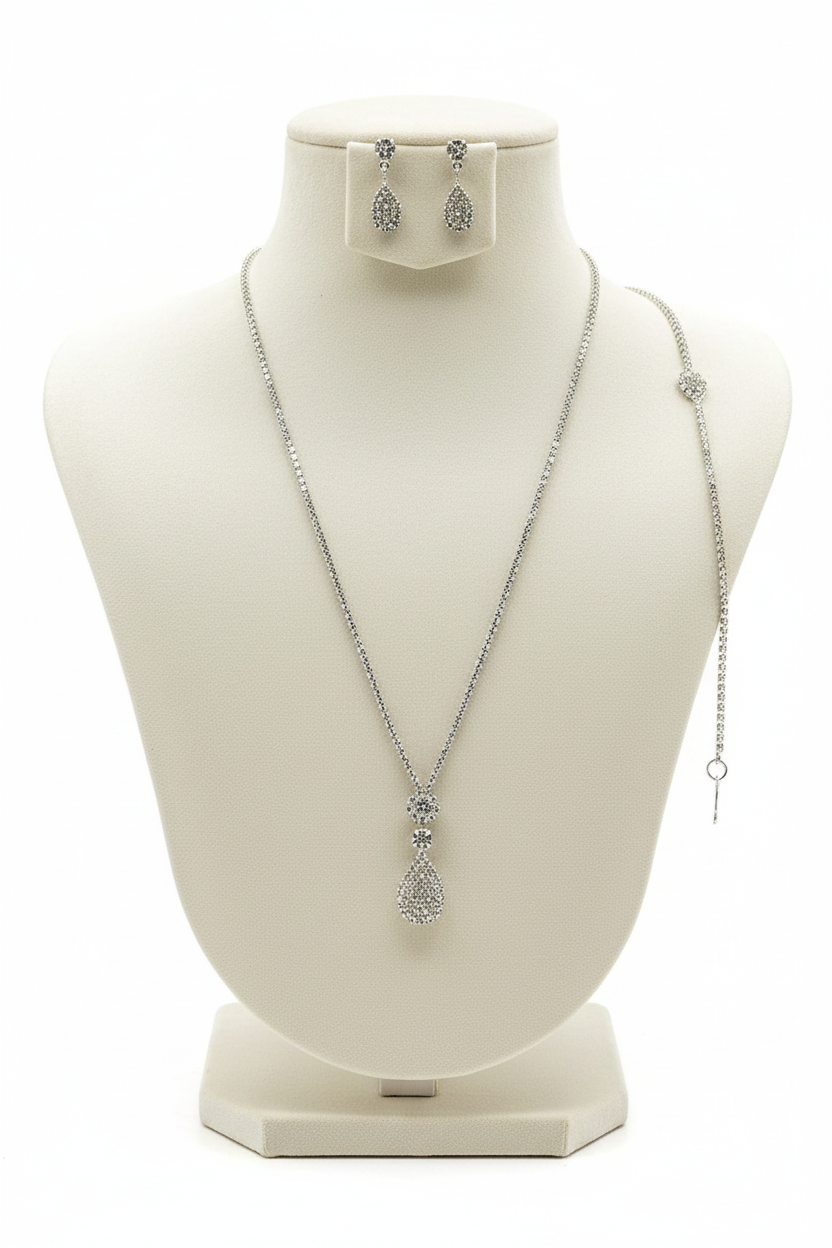 Silver necklace and earrings on a mannequin bust with a white background