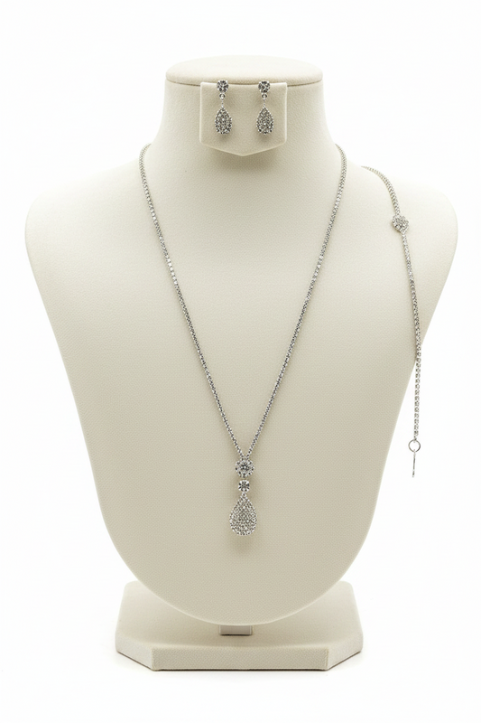 Silver necklace and earrings on a mannequin bust with a white background