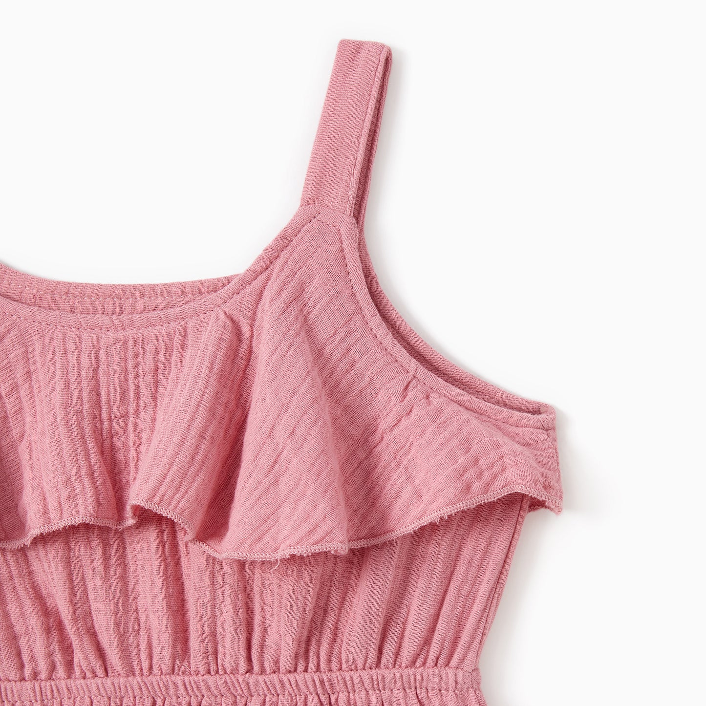 Pink ruffled top on a white background