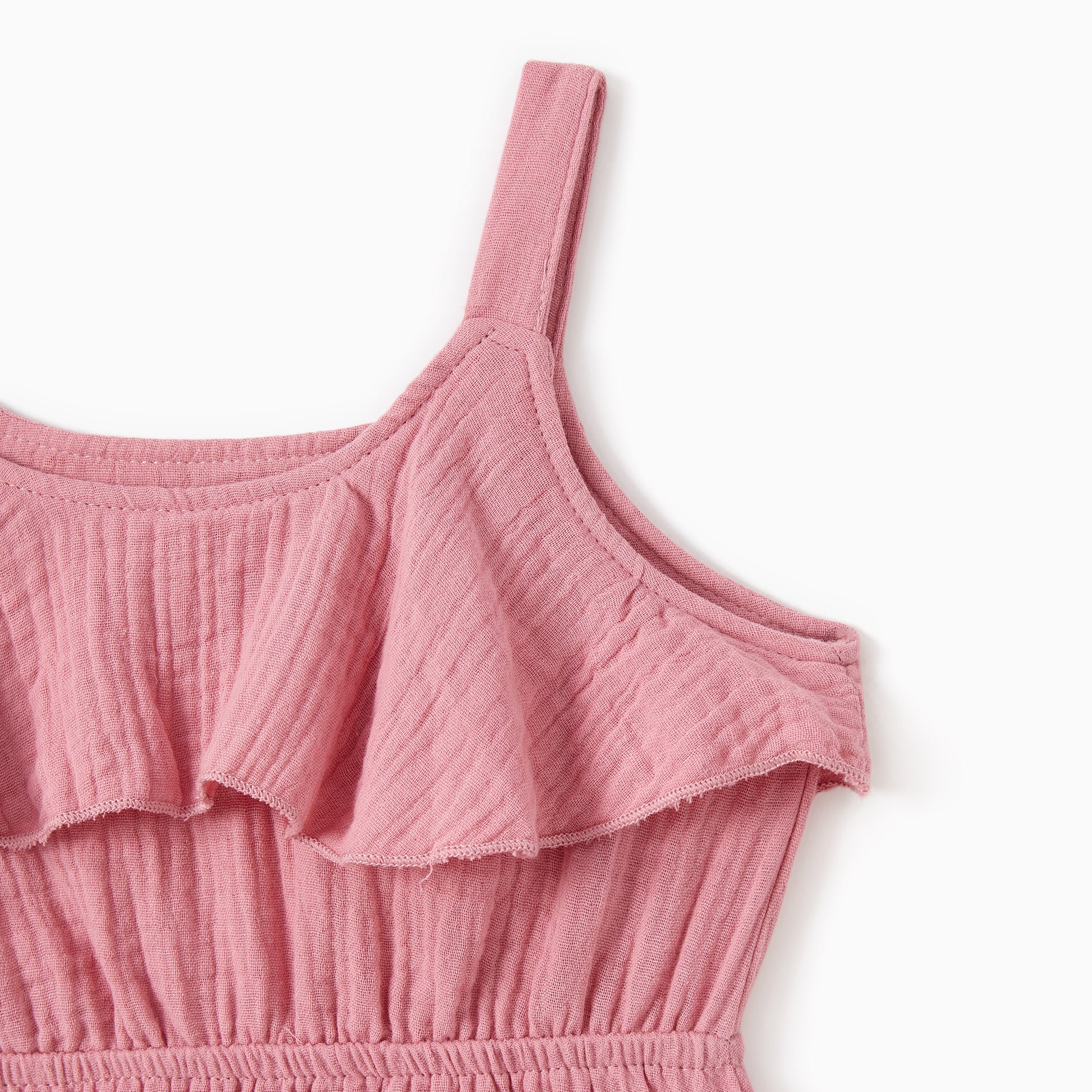 Pink ruffled top on a white background