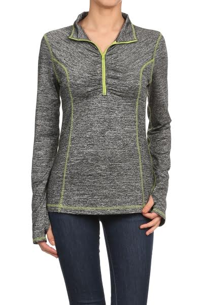 A woman wearing a gray heathered long-sleeve quarter-zip pullover with lime green contrast stitching and zipper trim, paired with dark blue jeans, against a plain white background.
